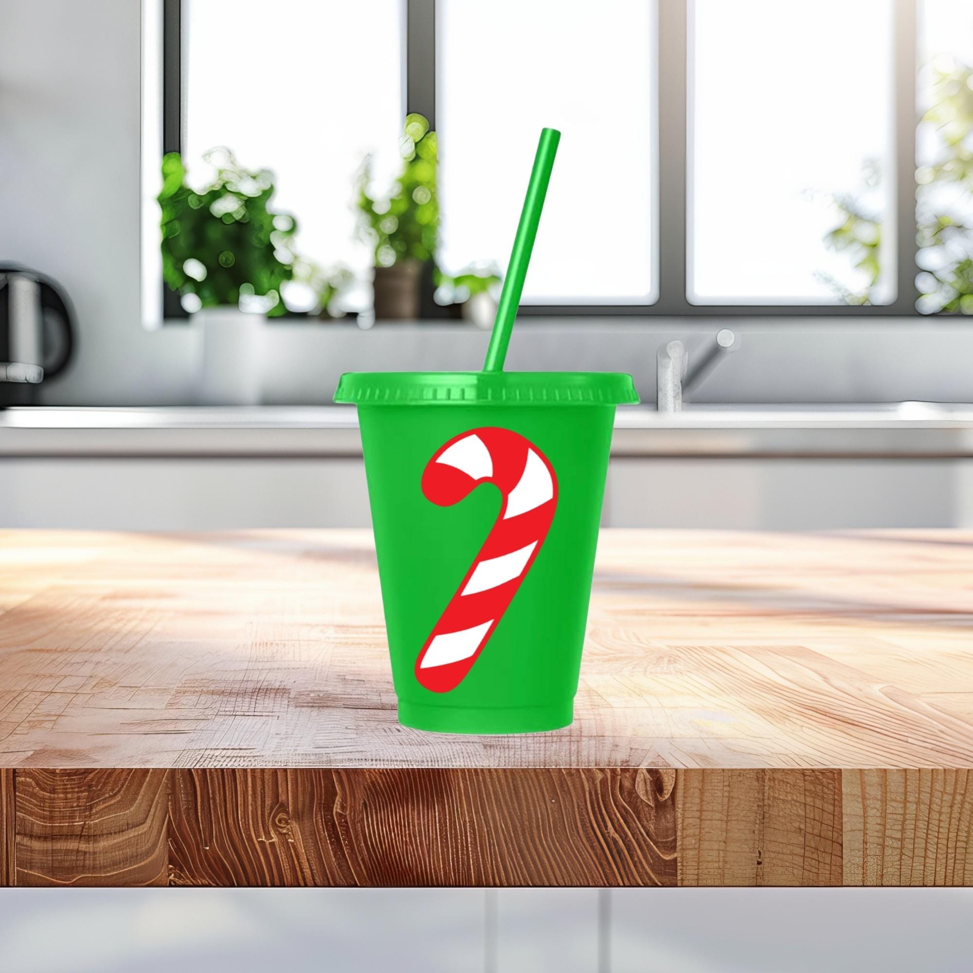 Green cup with candy cane design on a wooden table
