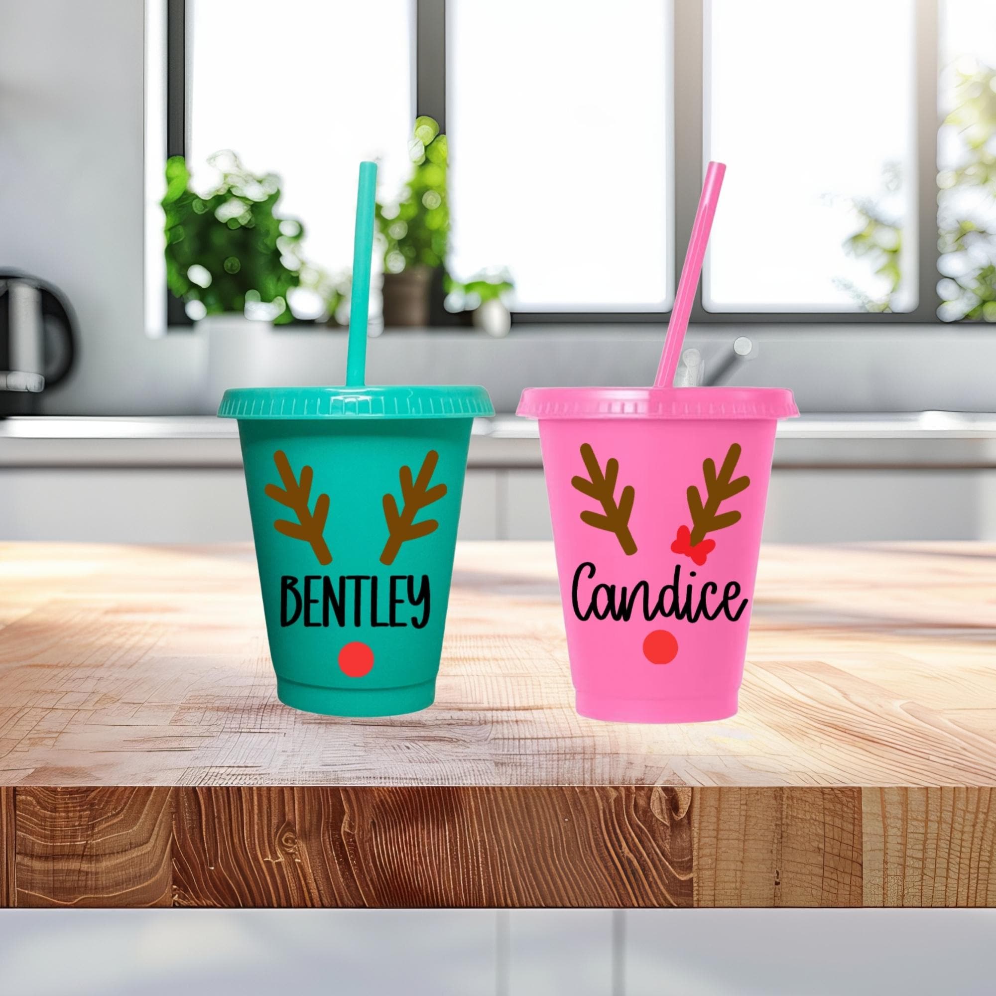 Two personalized tumblers with names 'Bentley' and 'Candice' on a wooden surface.