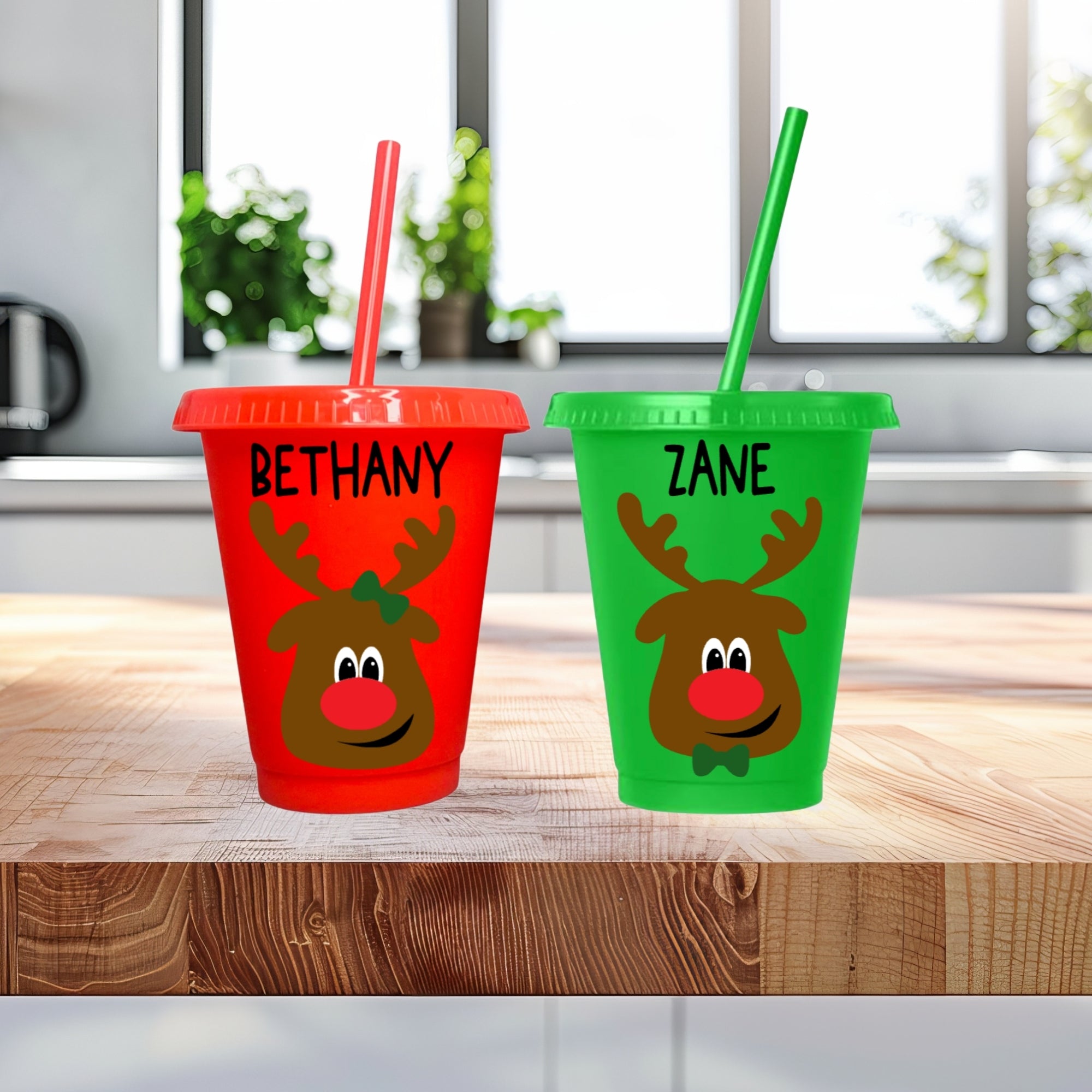 Personalized reindeer kids Christmas cups in red and green with custom name option.